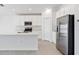 Modern kitchen with white cabinets, stainless steel appliances, an island with a sink, and ample counter space at 752 Trotters Dr, Eagle Lake, FL 33839