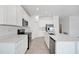 Modern kitchen showcasing white cabinets, stainless steel appliances, and a large island with a sink at 752 Trotters Dr, Eagle Lake, FL 33839