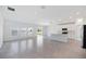 Open-concept living area with tile flooring, connecting to a modern kitchen and featuring a sliding glass door at 752 Trotters Dr, Eagle Lake, FL 33839