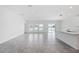 Bright, open-concept living space with tile flooring, a kitchen island, and picturesque lake views from large windows at 752 Trotters Dr, Eagle Lake, FL 33839