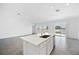 Modern open living area with an island and a lake view, seamlessly blending indoor and outdoor living at 752 Trotters Dr, Eagle Lake, FL 33839