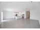 Spacious open-concept area featuring tile flooring, white walls, and a modern kitchen with stainless steel appliances at 752 Trotters Dr, Eagle Lake, FL 33839