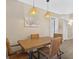 Dining area features a wooden table with four chairs and pendant lighting for a cozy atmosphere at 831 Retreat Blvd # 103, Davenport, FL 33897