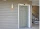 Exterior view of a door to a unit with stairs leading up on the side of the building at 831 Retreat Blvd # 103, Davenport, FL 33897