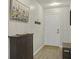 Inviting entryway with patterned wallpaper, shoe cabinet, and access to other rooms at 831 Retreat Blvd # 103, Davenport, FL 33897
