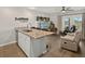 Open-concept living area featuring a kitchen island, modern furnishings, and plenty of light at 831 Retreat Blvd # 103, Davenport, FL 33897