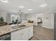 Spacious living room next to the kitchen and bedroom, featuring hardwood floors at 831 Retreat Blvd # 103, Davenport, FL 33897