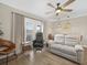 Comfortable living room with hardwood floors, stylish furniture, and sliding doors to the outside at 831 Retreat Blvd # 103, Davenport, FL 33897