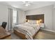Bedroom featuring a stylish headboard, hardwood floors, and a ceiling fan for comfort at 831 Retreat Blvd # 103, Davenport, FL 33897