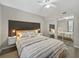 Bedroom featuring hardwood floors, built in lamps, and a mirrored closet for maximum storage at 831 Retreat Blvd # 103, Davenport, FL 33897