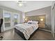 Bedroom featuring a stylish headboard, hardwood floors, and sliding glass doors for natural light at 831 Retreat Blvd # 103, Davenport, FL 33897