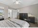 Bedroom featuring hardwood floors, ceiling fan, and a desk space perfect for a home office at 831 Retreat Blvd # 103, Davenport, FL 33897