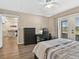 Bedroom features hardwood floors, a ceiling fan, a desk and access to an outdoor patio at 831 Retreat Blvd # 103, Davenport, FL 33897