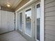 This is an outdoor patio with sliding doors and a storage shed providing extra space at 831 Retreat Blvd # 103, Davenport, FL 33897
