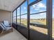 Relaxing screened porch with seating and a beautiful outdoor view at 831 Retreat Blvd # 103, Davenport, FL 33897