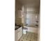 A bathroom with white cabinets, a tub and shower, and a patterned tile floor at 8843 Villa View Cir # 14-205, Orlando, FL 32821