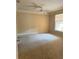 Bedroom with a ceiling fan, carpet and a large window at 8843 Villa View Cir # 14-205, Orlando, FL 32821
