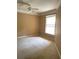 An empty bedroom with beige walls, carpet and a single window at 8843 Villa View Cir # 14-205, Orlando, FL 32821