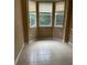 A breakfast nook area with tile floors, a window view, and beige walls at 8843 Villa View Cir # 14-205, Orlando, FL 32821