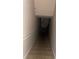 A stairwell featuring neutral colors, a sturdy handrail, and a door at the bottom at 8843 Villa View Cir # 14-205, Orlando, FL 32821