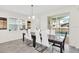 Bright dining room with modern table, seating for six, and view of the pool through sliding doors at 9033 Flamingo Key Way, Kissimmee, FL 34747