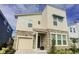Stylish two-story home showcasing stone accents, neutral stucco, and a convenient attached garage at 9033 Flamingo Key Way, Kissimmee, FL 34747