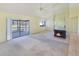 Bright living room with a cozy fireplace and sliding doors to the screened porch at 931 Brennam Pl, Longwood, FL 32750