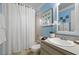 Bright bathroom featuring white tile, shower, and a vanity sink at 942 Cinnamon Ct, Altamonte Springs, FL 32714