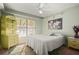 Cozy bedroom with a ceiling fan and large window for natural light at 942 Cinnamon Ct, Altamonte Springs, FL 32714