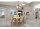 Open dining room with ample sunlight and a stylish chandelier creates an inviting space at 942 Cinnamon Ct, Altamonte Springs, FL 32714