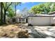 Inviting home with white exterior, black trim, well-kept lawn, and a driveway leading to an attached garage at 942 Cinnamon Ct, Altamonte Springs, FL 32714