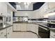 Bright kitchen with white cabinetry, tile floors and stainless steel appliances provides style and function at 942 Cinnamon Ct, Altamonte Springs, FL 32714