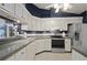 Stylish kitchen with white cabinets, updated countertops, stainless steel appliances, and ample storage at 942 Cinnamon Ct, Altamonte Springs, FL 32714