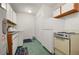 Well-equipped laundry room with a washing machine, dryer, and ample storage at 942 Cinnamon Ct, Altamonte Springs, FL 32714