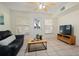 Bright living room with ample sunlight, neutral walls and furniture provides cozy comfort at 942 Cinnamon Ct, Altamonte Springs, FL 32714
