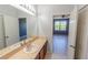 Bathroom featuring hardwood cabinets and an adjoining bedroom at 9620 Doris Ln, Orlando, FL 32829