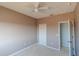 This bedroom has neutral walls, a closet, and a ceiling fan at 9620 Doris Ln, Orlando, FL 32829