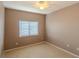 A cozy bedroom with neutral walls, carpet, a ceiling fan, and a window providing plenty of natural light at 9620 Doris Ln, Orlando, FL 32829