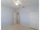 Bright bedroom featuring neutral-colored walls, plush carpet, a ceiling fan, and a double-door closet at 9620 Doris Ln, Orlando, FL 32829