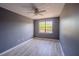 Well-lit bedroom with a ceiling fan, hardwood floors, and neutral paint at 9620 Doris Ln, Orlando, FL 32829