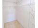 A carpeted, walk-in closet featuring wall-mounted shelving at 9620 Doris Ln, Orlando, FL 32829