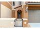Close-up of a home's inviting gated entrance and arched doorway, complete with a charming wreath at 9620 Doris Ln, Orlando, FL 32829