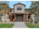 A well-maintained townhome with a neutral color scheme, complemented by a red tile roof and a quaint gated entrance at 9620 Doris Ln, Orlando, FL 32829