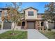 Charming townhome featuring a two-car garage and well-manicured landscaping for a welcoming curb appeal at 9620 Doris Ln, Orlando, FL 32829