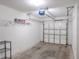 Clean garage with painted walls, storage shelves, and automatic door at 9620 Doris Ln, Orlando, FL 32829
