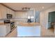 Open kitchen featuring stainless steel appliances and a central island at 9620 Doris Ln, Orlando, FL 32829