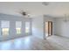A sunlit living room featuring wood floors, a modern ceiling fan, and sliding glass doors at 9620 Doris Ln, Orlando, FL 32829