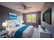Staged main bedroom featuring a king bed, ceiling fan, scenic art, and an abundance of natural light at 9620 Doris Ln, Orlando, FL 32829