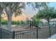 Community playground with slides, swings, and a secure fence for recreation and safety at 9620 Doris Ln, Orlando, FL 32829