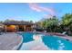 Community pool featuring lounge chairs, palm trees, and covered area perfect for relaxation at 9620 Doris Ln, Orlando, FL 32829